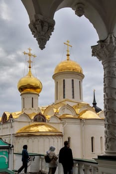 Sergiev Posad, Moscow region, - 19 April 2021 Trinity Cathedral in the Sergius Lavra on a spring day through the arches of the refectory building
