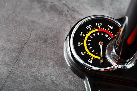 Hand air pump manometer for pressure control on a dark background close-up