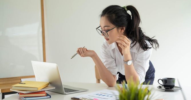 Portrait Of Attractive Asian young business entrepreneur woman working at modern office.