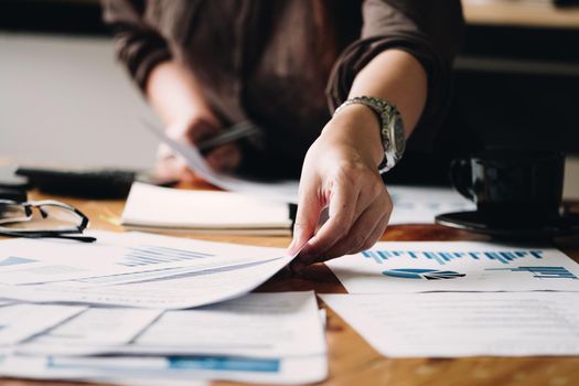Business woman investment consultant analyzing company annual financial report balance sheet statement working with documents graphs. Concept picture of business, market, office, tax..N