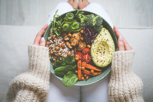 Woman eating vegan or vegetarian meal. Buddha vegan bowl with fresh vegetables. Vegan food plate. Healthy eating. High quality photo