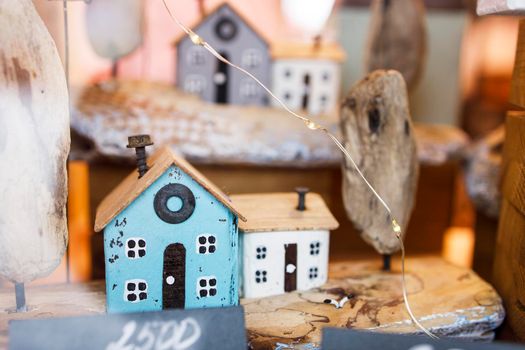 Moscow, Russia - 20 December 2021, wooden Christmas toys houses for the Christmas tree at the fair