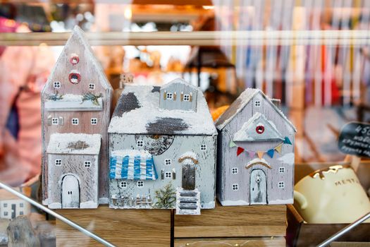 Moscow, Russia - 20 December 2021, wooden Christmas toys houses for the Christmas tree at the fair