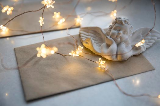 Apartment decoration for Christmas. Plaster angel on the envelope and a garland decorate the interior for Christmas