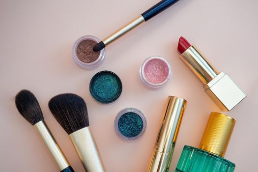 set of beauty cosmetics for female face and eye makeup on pink background . photo