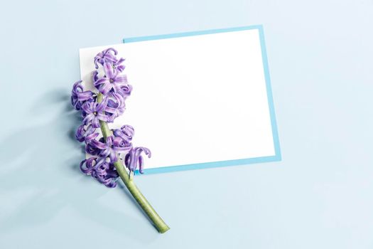 Greeting card for Valentine's Day or special event. White and blue peace of paper on a light blue background. Copy space. Place for text