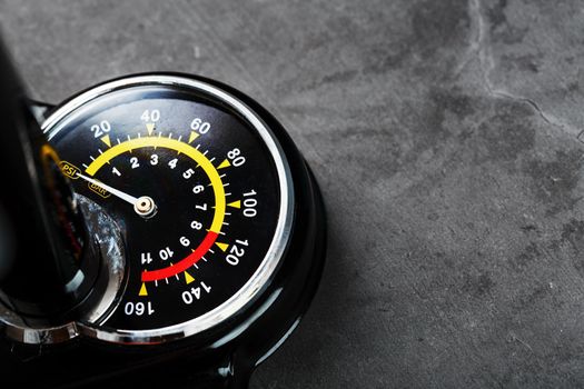 Hand air pump manometer for pressure control on a dark background close-up