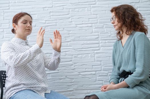 The psychotherapist conducts a hypnosis session. Female patient under hypnosis