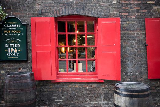 London, UK, - 23 December 2020, LONDON, ENGLAND - December 17, 2020 Window with red shutters, decorated with a drawing with a horse in a traditional Christmas style about the south bank in London