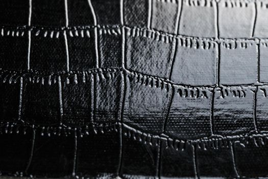 Black crocodile skin texture as background in full screen closeup