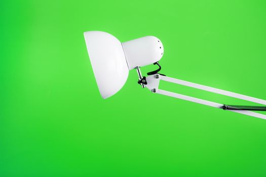 White table office lamp on green background with space for text and idea concept