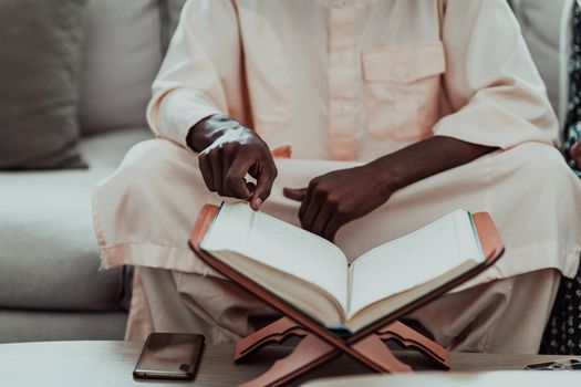 African Muslim couple at home in Ramadan reading Quran holly Islam book. High-quality photo