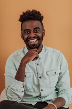 African student using laptop computer to study and make business connections yellow background. High quality photo