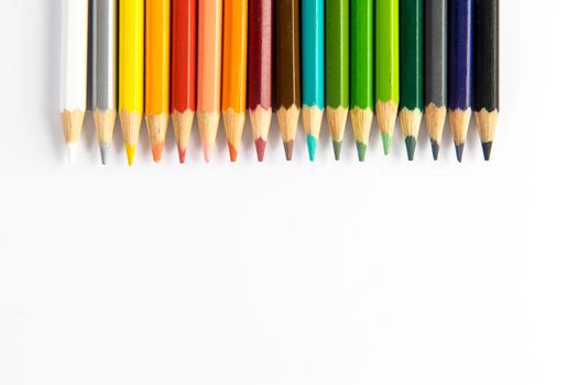 Colored pencils isolated on a white background. Place for text. Copy space
