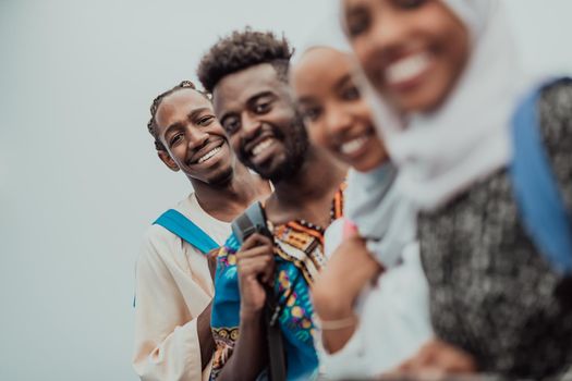 photo of a group of happy African students talking and meeting together working on homework girls wearing traditional Sudanese Muslim hijab. High-quality photo