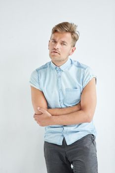 Brutal man in a shirt with short sleeves , his fists clenched, slightly bent, under the gaze of the forehead. High quality photo