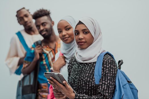 photo of a group of happy African students talking and meeting together working on homework girls wearing traditional Sudanese Muslim hijab. High-quality photo