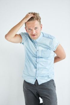 Brutal man in a shirt with short sleeves , his fists clenched, slightly bent, under the gaze of the forehead. High quality photo