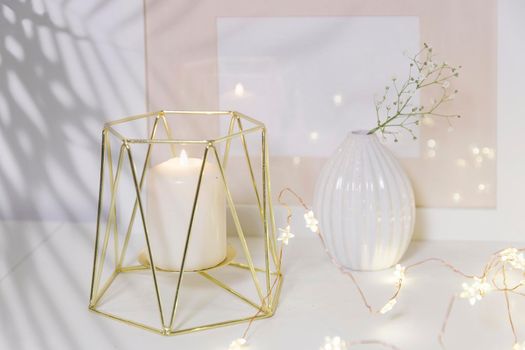 Two unopened hyacinths in a glass vase with artificial ice. Interior view in modern scandinavian style with painting canvas or poster on the wall. Living room, chest of drawers with vases.