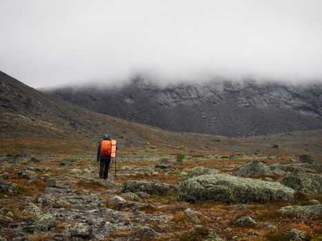 Hiker woman walking in a mountain rocky path. photo