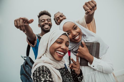 A group of multiethnic students takes a selfie with a smartphone on a white background. Selective focus . High-quality photo