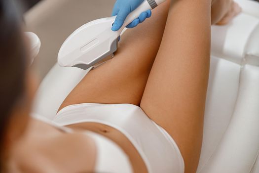 Closeup of woman getting epilation with ipl machine in beauty salon. Cosmetology, hair removal