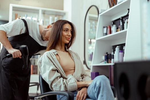 Young female customer doing her hair in beauty salon. Beauty, care, hairstyle