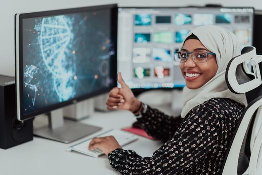 Young Afro-American modern Muslim businesswoman wearing a scarf in a creative bright office workplace with a big screen. High-quality photo