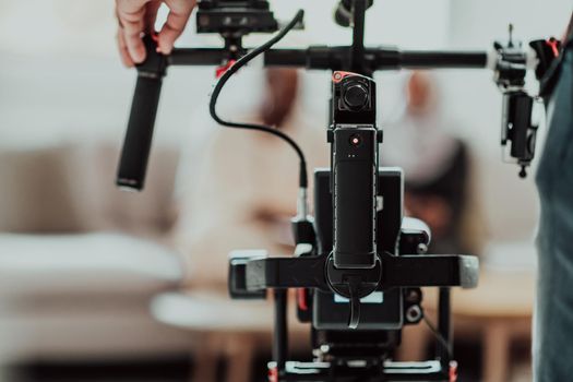 Cameraman working on professional camera taking stock footage. High-quality photo