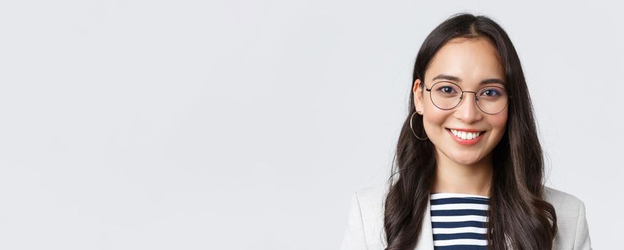 Business, finance and employment, female successful entrepreneurs concept. Close-up of smiling asian beautiful businesswoman wearing glasses and suit, looking confident and happy.