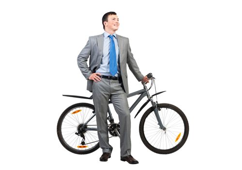 Handsome man in grey business suit and tie standing near bike. Cheerful businessman with bicycle looking up. Portrait of male cyclist with hand on waist isolated on white background.