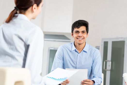 portrait of a young man at a business meeting. concept of team work