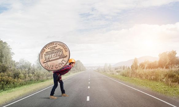 Builder man carrying on his back big cent coin