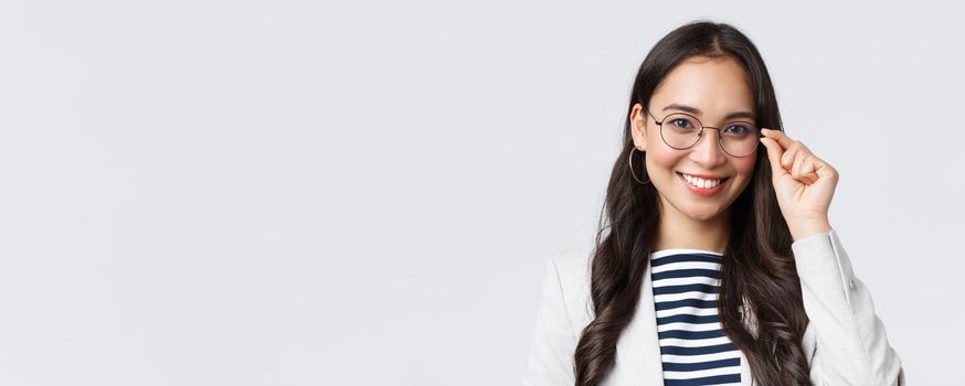 Business, finance and employment, female successful entrepreneurs concept. Talented young asian female IT programmer in glasses, customer support manager smiling at camera.