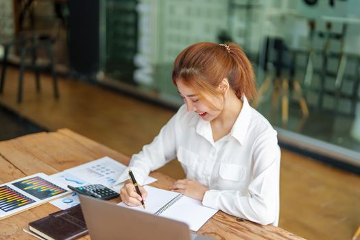 data analysis, plan, marketing, accounting, audit, Portrait of asian business woman working planning marketing using statistical data sheet and computer to present marketing plan project at meeting