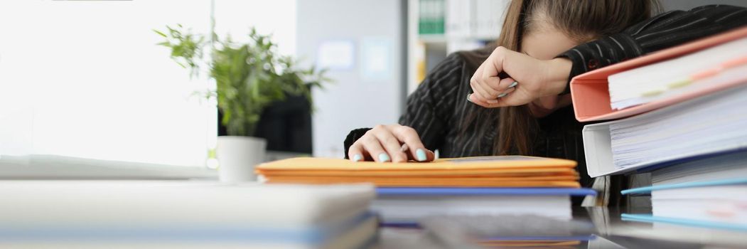 Close-up of tired overworked woman sleeping on workplace. Stressful and exhausted clerk in office, lots of stack with documents on desk. Hardworker, businesswoman, job concept