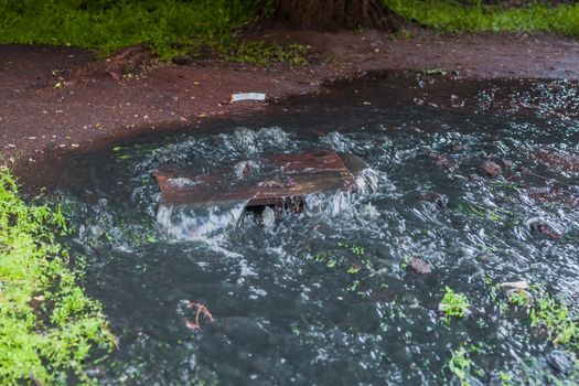 Outflow of water from a well. Breakthrough of the water supply system.