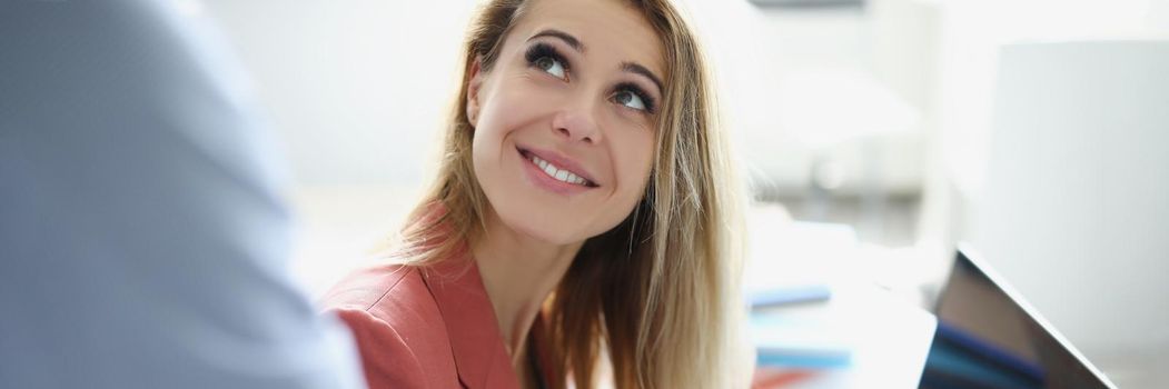 Portrait of smiling worker woman helping colleague with project. Blonde employee use laptop, friendly communication with team. Business, office life, occupation, career concept