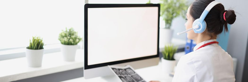 Close-up of woman work in clinic support service, wearing headset and use computer in office, call patients with analysis results. Clinic centre, secretary, medicine, help concept