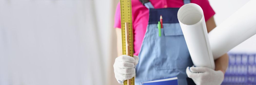 Close-up of person worker holding paper, ruler and pencil. Time to create plan for construction project, make corrections, creative idea, new layout. Foreman, renovation, project concept