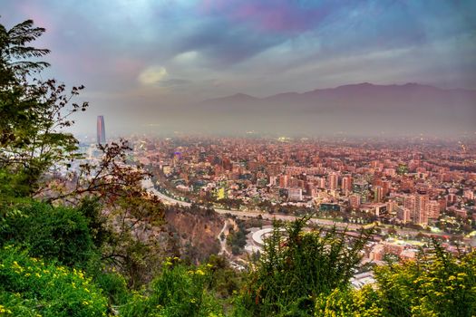 Santiago de Chile city downtown pollution at dusk with Andes mountain range in the background