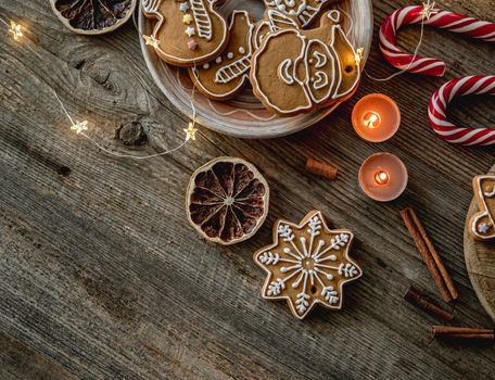 Top view of festive gingerbread beside cocoa and christmas decorations