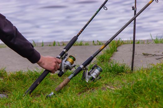 Close-up of a fishing rod wheel, a man is fishing. Nature. selective focus