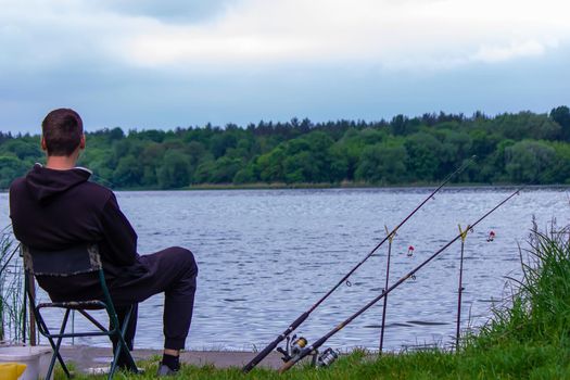 Close-up of a fishing rod wheel, a man is fishing. Nature. selective focus