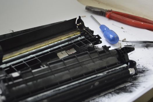 Charging the laser printer cartridge with toner the powder