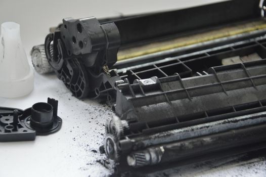 Charging the laser printer cartridge with toner the powder