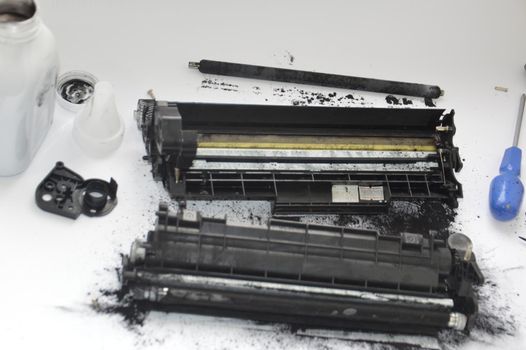 Charging the laser printer cartridge with toner the powder