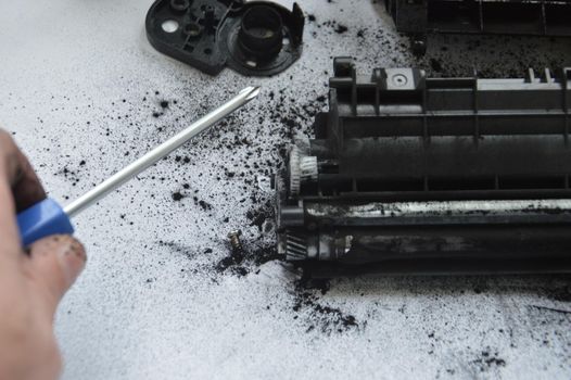 Charging the laser printer cartridge with toner the powder