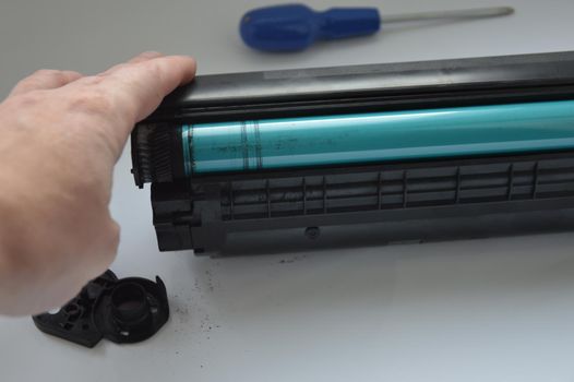 Charging the laser printer cartridge with toner the powder