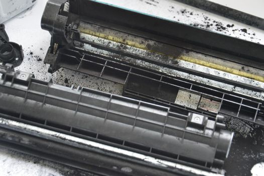 Charging the laser printer cartridge with toner the powder